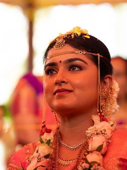 The bride's expression during a key ritual. The makeup is designed to be elegant and non-distracting, allowing the focus to remain on the sacredness of the moment.