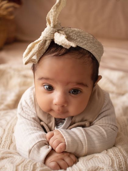 A close-up of an alert newborn during tummy time. I love capturing their beautiful, curious eyes and tiny expressions.