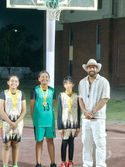 The winning girls' team poses with their medals after a late-night final in the 3x3 basketball tournament. Their dedication to the game is inspiring.