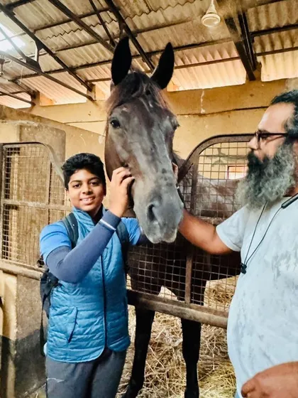 The perfect match is everything. We take great pride in finding the right horse for each rider's ambitions, creating a true partnership. This moment captures the excitement of a young rider meeting his new partner, Dreamboy.