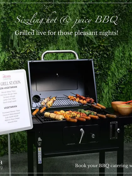 Our live grill station set up for a pleasant evening event. The menu board displays the vegetarian and non-vegetarian options available, including various tikkas and kebabs.