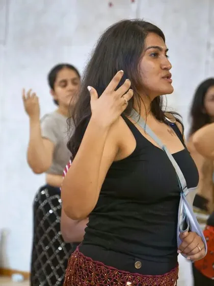 A candid shot of dancers listening intently during a workshop. These events are all about deep learning and shared passion.