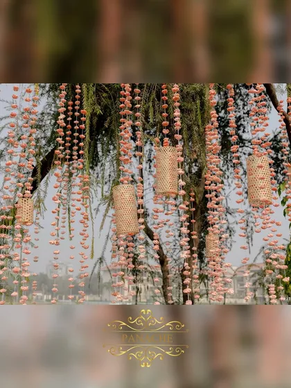 A close-up of the delicate sola wood flower and cane basket hangings that adorned the trees throughout the venue.