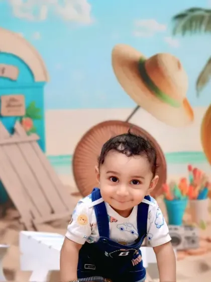 This little beachgoer gives a sweet, shy smile, ready for a day of fun in the sun in our studio.