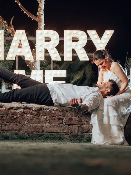 A classic proposal setup with "Marry Me" in lights. I can help you stage grand romantic gestures or capture candid moments, ensuring your pre-wedding album has a variety of emotional and stylish shots.