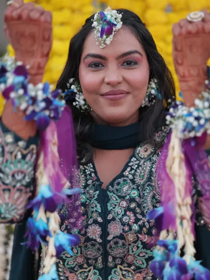 A close-up of the Haldi bride, showing off her intricate floral maang tikka and earrings. The eye makeup is soft and pretty, perfect for the occasion.
