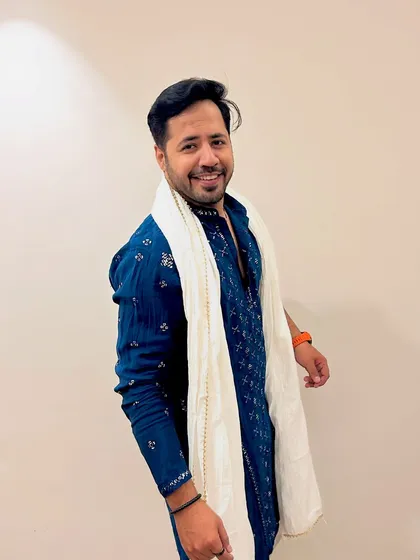 A full-length view of the blue kurta with a white scarf. A simple, elegant, and stylish look for any pre-wedding event.