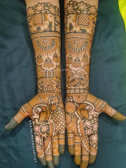 This bridal henna is packed with traditional symbols, including temple bells, elephants, and the sacred swastika for blessings.