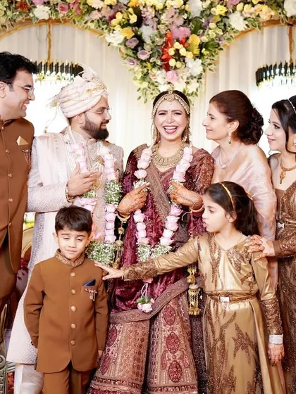 A classic family portrait taken during a wedding celebration. We carefully compose these shots to feel relaxed and natural, ensuring everyone from the children to the adults looks their best.