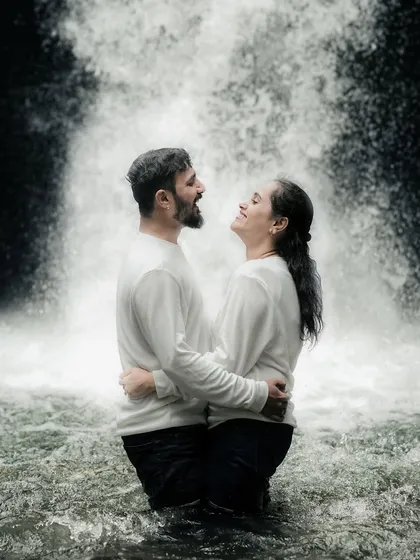 A beautiful, happy embrace in the midst of a waterfall. This shot captures the adventurous spirit of the couple and the pure joy of the moment.