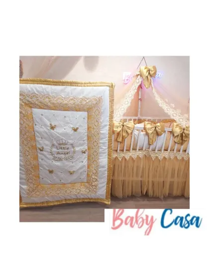 The complete "Little Angel" set, including the beautifully detailed quilt. The gold and white color scheme, combined with butterfly embroidery and lace, makes this a truly standout nursery design.