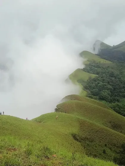 Standing above the clouds at Netravati Peak. This is the feeling of accomplishment and peace we chase on our treks. We handle all the logistics so you can focus on the climb and this incredible view.