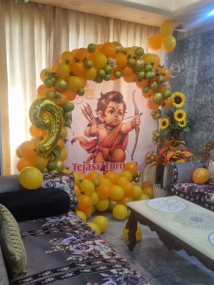A wide-angle view of the 'Jai Shri Ram' themed birthday, showing how the decoration fits into a living room space.