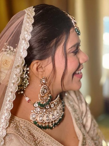 A detailed look at this bride's elegant wedding style, from her flawless makeup to her intricate floral bun.