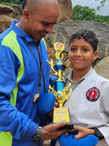 Presenting a trophy to one of our dedicated young students. Seeing the pride on their faces is my greatest reward as a coach.