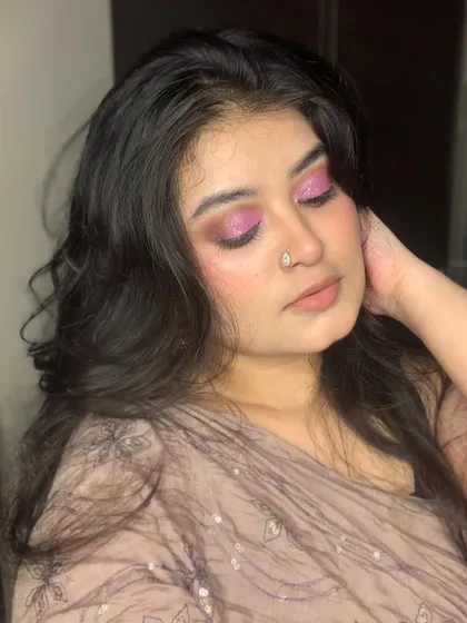 The light catching the glitter on this pink smokey eye shows how impactful shimmer can be for an evening look.