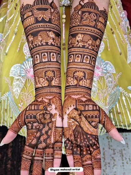 A stunning full-arm design with elephants, swans, and other traditional motifs against a beautiful yellow backdrop.