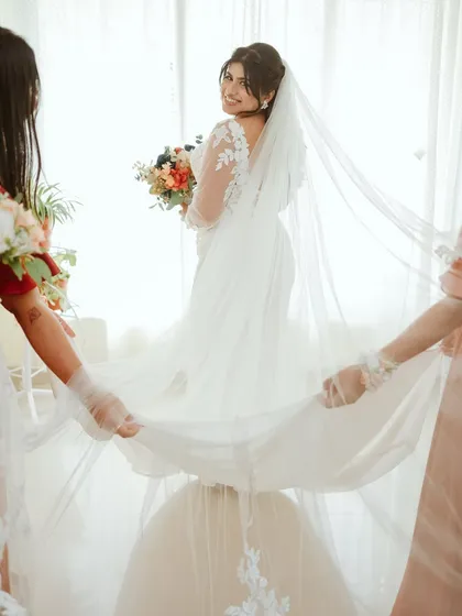 A lovely moment as the bridesmaids help with the bride's veil.