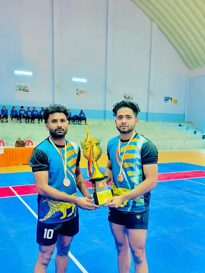 Two of my players holding the trophy after qualifying for the All India University Games. Academic and sports excellence go hand in hand.