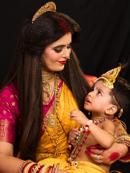 A heartwarming shot of Skandmata with a child representing her son, Kartikeya, adding a narrative element to the portfolio.