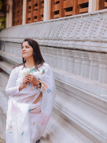 A series of peaceful portraits taken at a temple. The model's white saree contrasts beautifully with the intricate stone architecture, creating a sense of calm and serenity.