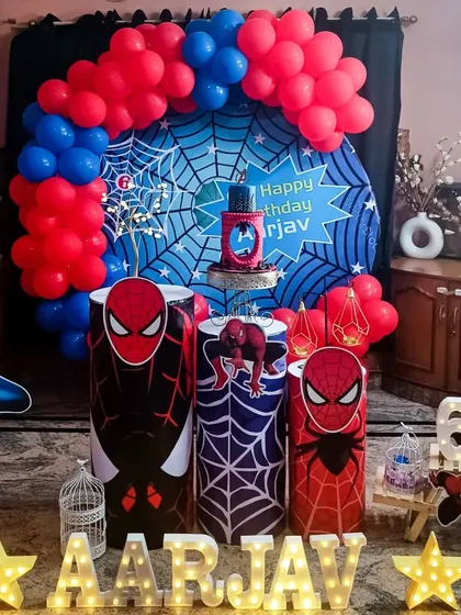 An action-packed Spider-Man theme birthday party. This custom setup includes a web-slinging backdrop, character cutouts, and themed pedestals to make any little hero's dream come true.