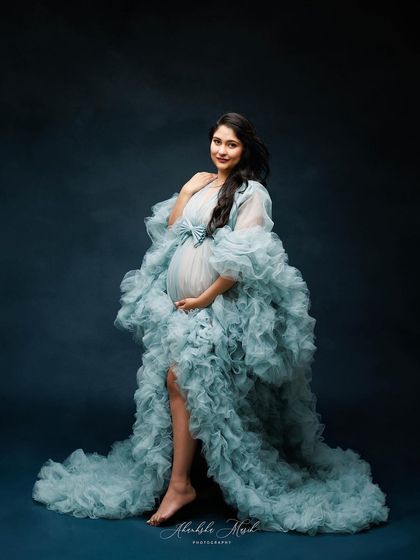 Wrapped in a cloud of ethereal blue ruffles, this gown creates a stunning, high-fashion silhouette that feels both gentle and powerful.