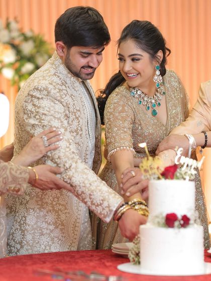 Cutting our engagement cake together. Our coordinated neutral outfits look elegant and timeless, ensuring our photos will be cherished for years to come without looking dated.