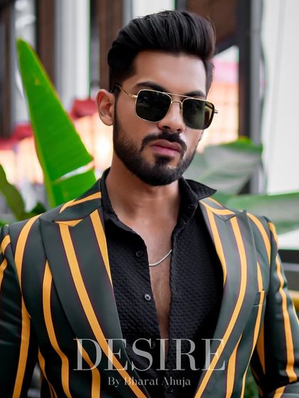 A confident portrait in the green and yellow striped blazer. This piece merges vintage cool with modern tailoring for a truly unique look.