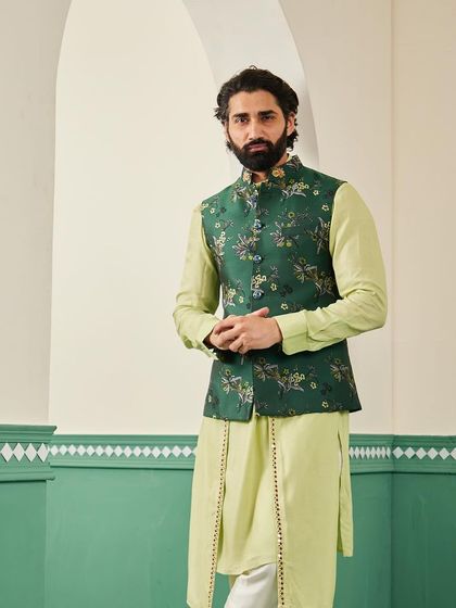 A mid-shot of the emerald green bundi set, focusing on the fit of the jacket and the intricate floral pattern that makes it a standout piece.