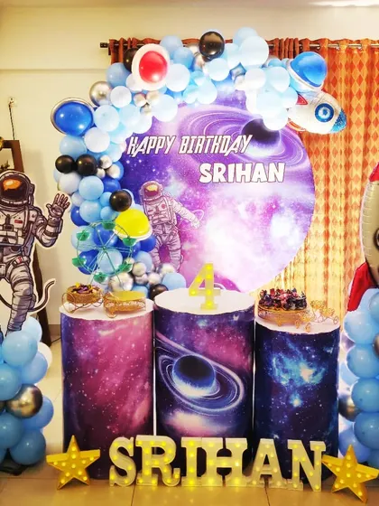 An out-of-this-world space theme for Srihan's 4th birthday. I used a galaxy-print backdrop, astronaut and rocket cutouts, and planet-themed cake stands to create an immersive cosmic adventure for the little explorer.