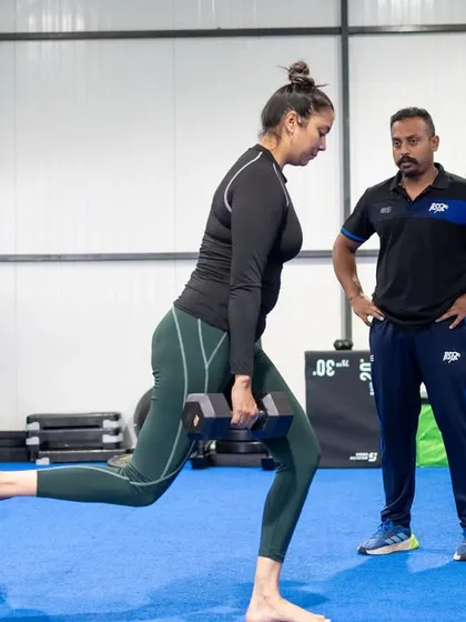 Every repetition matters. Here, I am providing real-time feedback to a female athlete performing a Bulgarian split squat, a key exercise for unilateral strength and stability. This one-on-one attention to detail ensures every movement is performed with purpose, maximizing results and minimizing injury risk.