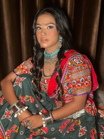 This image captures the complete essence of the Navratri look, from the colorful ghagra choli to the oxidized silver jewelry and vibrant makeup.