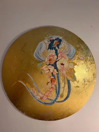 The jellyfish artwork in progress. Here, the main colors and forms have been painted in, showing the ethereal creature beginning to take shape against the radiant gold background.