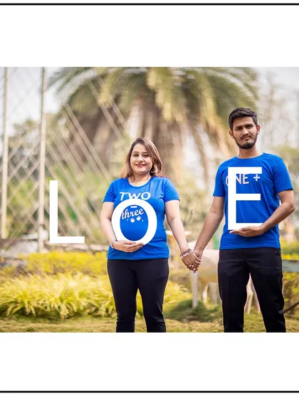 Using "LOVE" props to add a creative and fun touch to this couple's maternity photo.