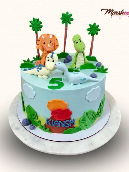 A roarsome treat for a 5th birthday! This dino-themed cake is a delicious combination of salted caramel and chocolate, topped with four friendly, handmade, and completely edible dinosaurs.