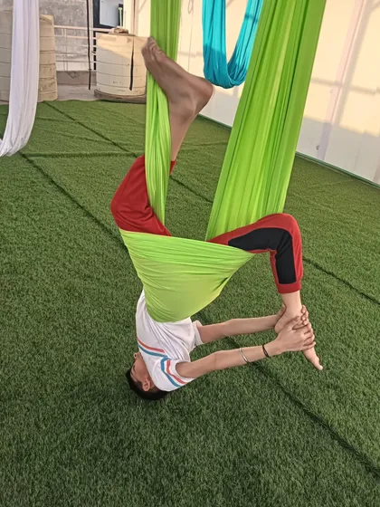 This pose is a playful way to stretch the hamstrings and back. Kids are naturally flexible, and aerial yoga helps them maintain that.
