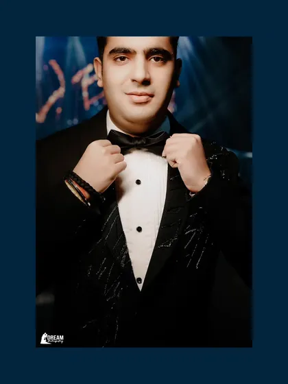 A dapper portrait of groom Isht, adjusting his bow tie before his Sagan and Cocktail celebration in Dubai.