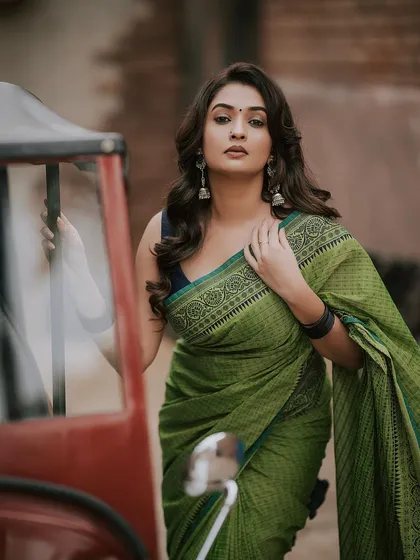 We can find beauty anywhere. This outdoor fashion shoot combines a traditional green saree with a rustic auto-rickshaw, creating a unique contrast. It shows how we can blend modern Indian fashion with everyday elements for a memorable portrait.