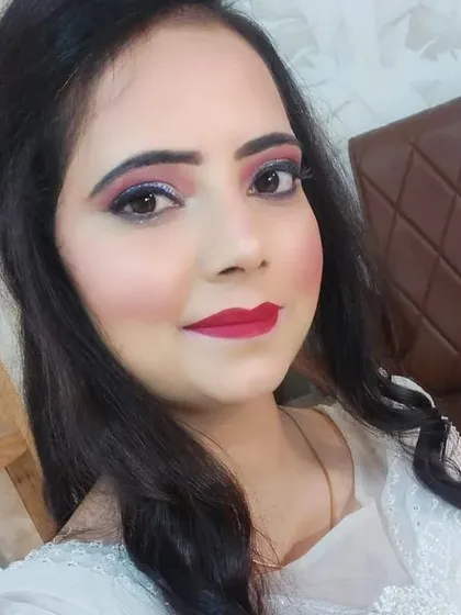 A classic party makeup look featuring a shimmery purple and pink smokey eye paired with a bold red lipstick. This look is versatile and suits many different outfits.