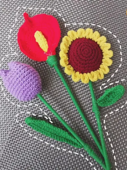 A collection of my single flower sticks: a purple tulip, a yellow and red sunflower, and a red casa lily. You can buy these individually to create your own arrangement.
