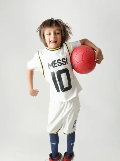 For the little Messi fan! We captured his passion for football in this energetic studio shoot, letting him show off his moves and his favorite jersey.