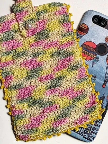 This multi-colored utility pouch shows how we can use variegated yarn to create a unique, striped pattern. It's a perfect fit for a smartphone.
