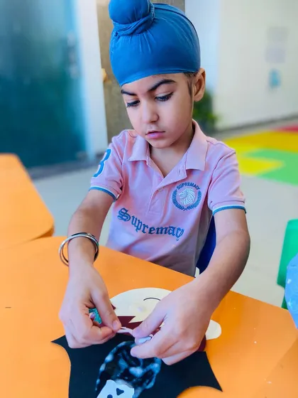 A young boy carefully adds cotton to his pirate craft, a great sensory element.
