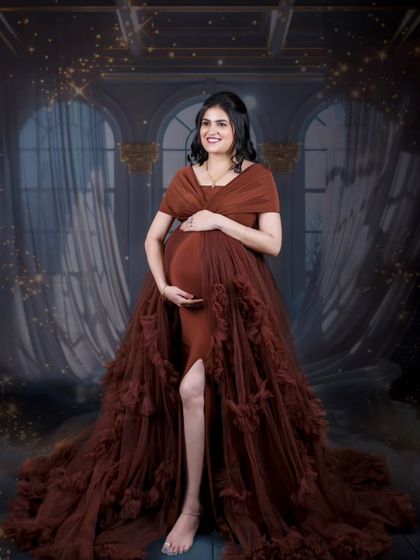 A glamorous solo shot with a touch of sparkle. The background effects add a magical feel to this portrait of the mom-to-be in a beautiful flowing gown.