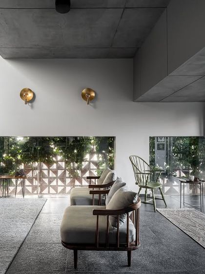 We designed a long, eye-level cutout window that runs the length of the living room, offering curated glimpses of the garden greenery. This feature, combined with the fully opening doors, ensures the space is always filled with natural light and views.