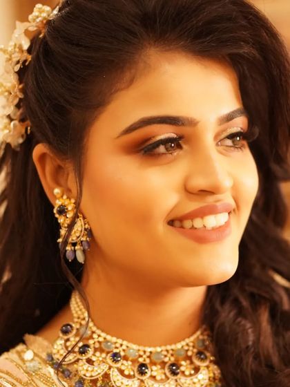 A close-up of Payal's dreamy reception makeup. The sparkling diamond glitter on her eyes and the perfectly defined brow create a look that is both glamorous and sophisticated, highlighting her joyful expression.