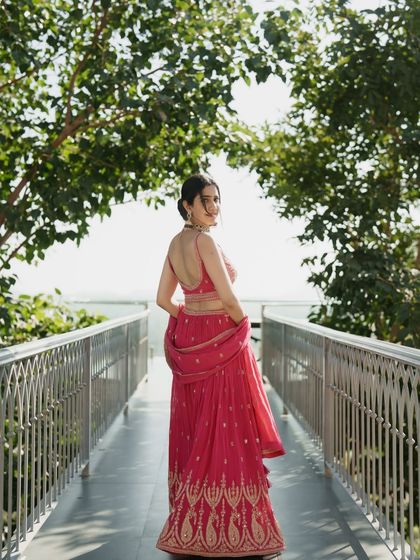 A full-length shot showing the beautiful flare of the pink lehenga. I love creating dynamic shots that showcase the entire outfit.