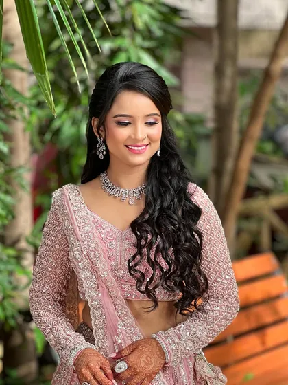 A candid, smiling shot of the engagement bride in a beautiful outdoor setting.