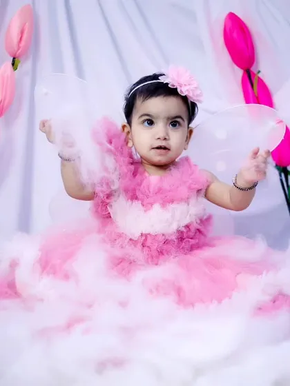 This little fairy is showing off her wings in our dreamy, cloud-filled studio.